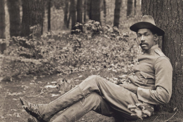 Reuben Griffin seated against a tree, about 1901