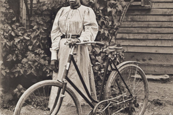 Rose Perkins posing with her bicycle, 1900