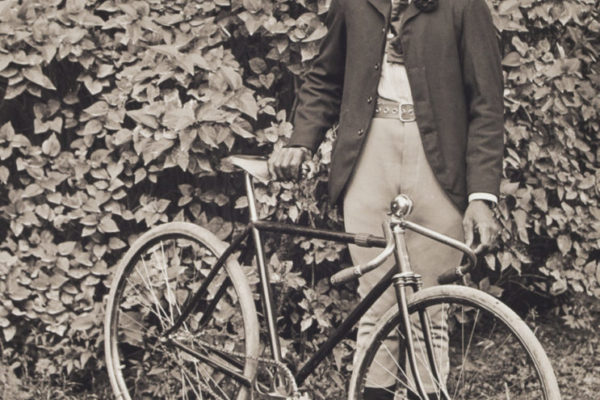 Isaac "Ike" Perkins posing with his bicycle, about 1901
