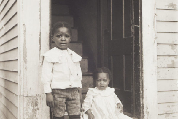 Two children in a doorway, about 1902